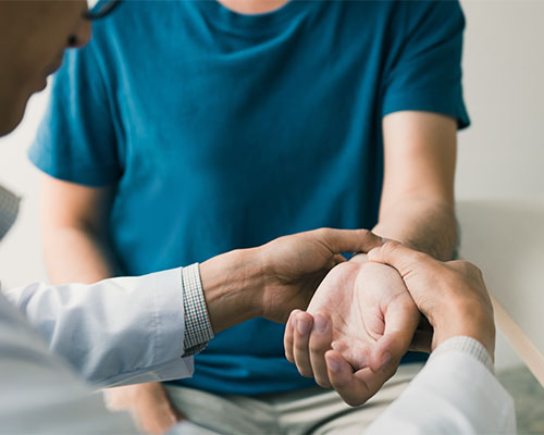 walk-in Doctor checking patient's wrist pain