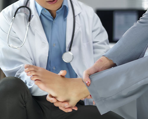 walk-in Doctor checking patient's foot pain